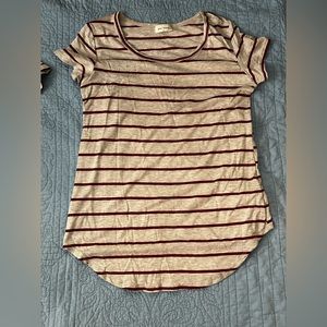 this shirt is from free kisses is grey with red stripes and is round at bottom